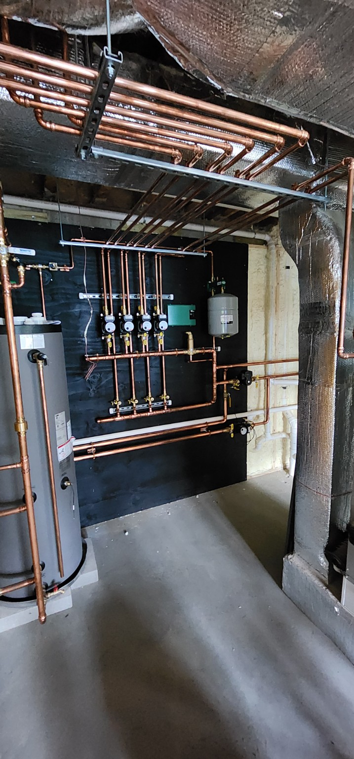 Multi-zone hydronic heating system with copper piping, four circulators and expansion tank
